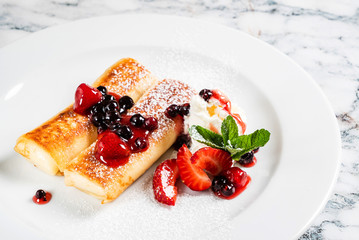 pancakes with strawberries and mint