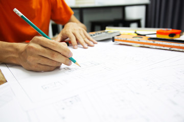 Architect Designing in blueprint at Construction Site With drawing equipment.concept