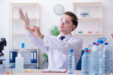 Young male chemist experimenting in lab