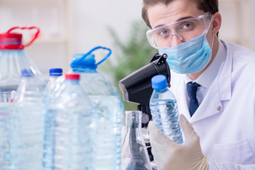 Young male chemist experimenting in lab