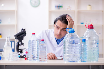 Young male chemist experimenting in lab