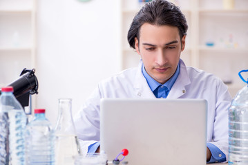 Young male chemist experimenting in lab