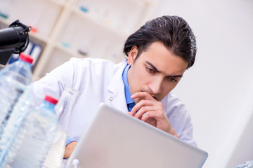 Young male chemist experimenting in lab