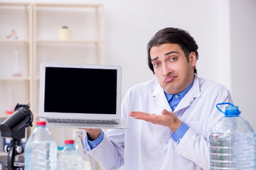 Young male chemist experimenting in lab
