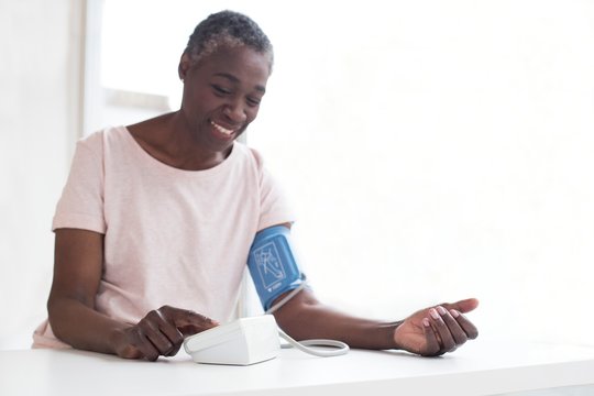 Woman testing blood pressure