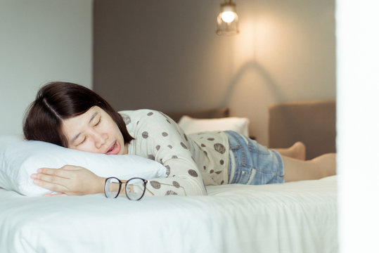 Asian Woman Snoring Because Due To Tired Of Work,Female Snor While Sleeping Open Your Mouth On Bed