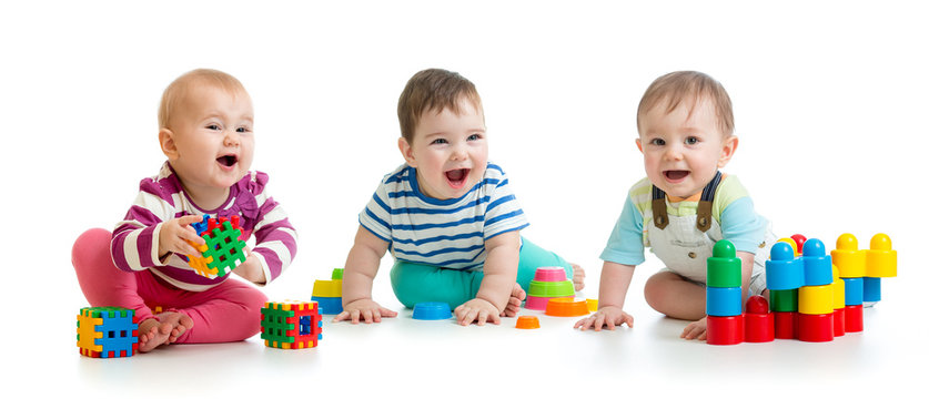 Nursery babies toddlers playing with color toys isolated on white background