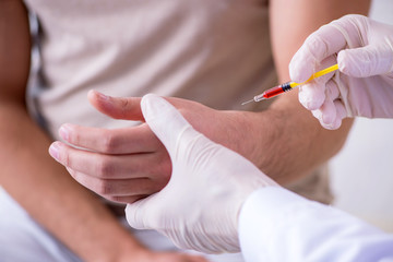 Male patient visitng doctor for shot inoculation 