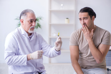 Male patient visitng doctor for shot inoculation 