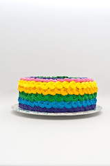 Colorful cake ready to eat. Isolated on white background. Side view. Copy space. Vertical shot.