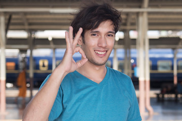 Obraz premium man pointing up ok hand sign; good, correct, ok, accepting, approving concept