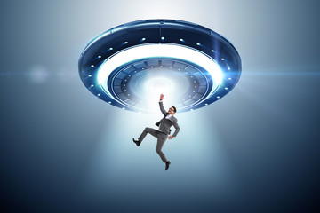 Flying saucer abducting young businessman 