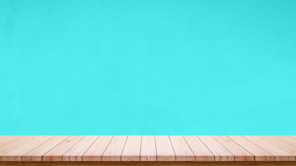 Empty wooden table with sky blue wall background.