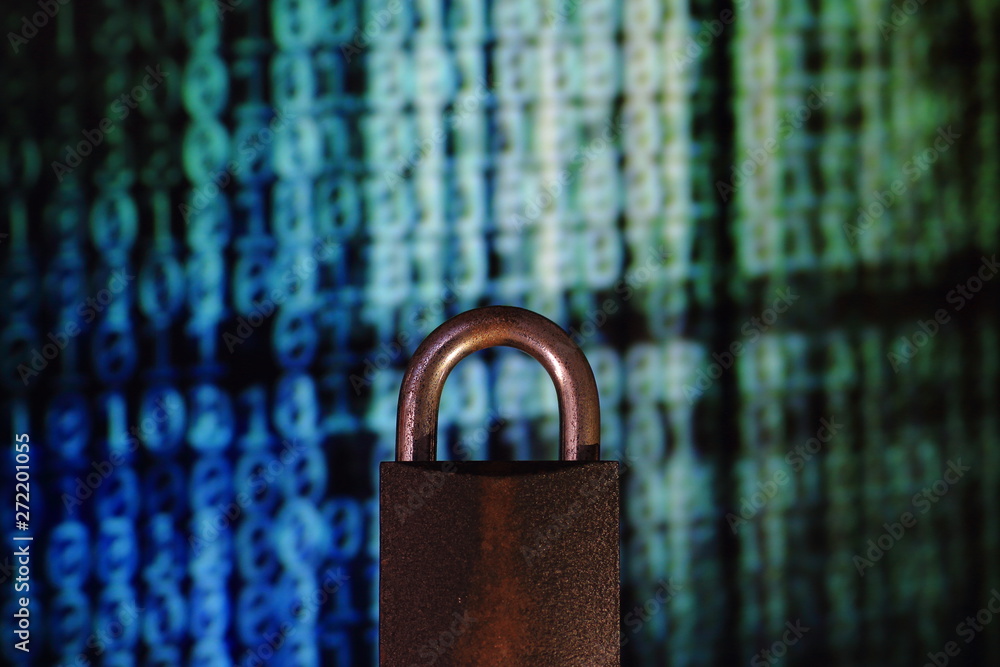 Poster binary computer language matrix blurred be hide an iron padlock. sign of computer privacy protection
