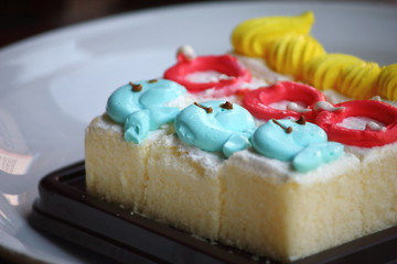 Slice cake piece with cream on top