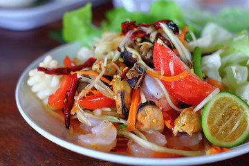 A delicious spicy papaya salad with seafood in thaifood