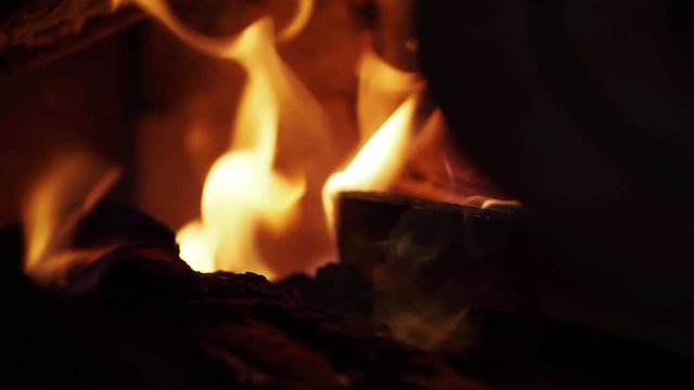 Man kindles the stove in the house  Fire, its flame licking the wood stacked in the kiln