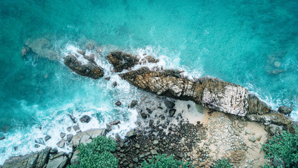 Danger sea wave crashing on rock coast with spray and foam before storm in Phuket, Thailand