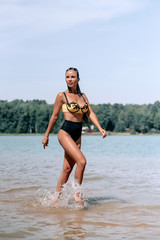 Beautiful Sexy young woman in bikini at location of mountain river