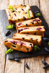 Berry cake with honeysuckle and mint on the board closeup on a table. vertical