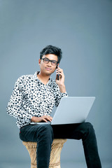 Young indian employee with laptop