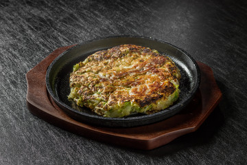 お好み焼き  Okonomiyaki is a Japanese-style pancake