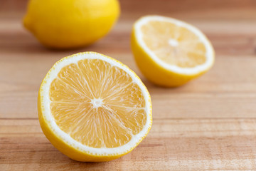 Fototapeta na wymiar Fresh yellow lemon and half a lemon on a wooden table.