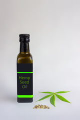 brown bottle with hemp seeds and leaf isolated