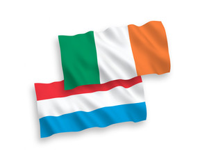 National vector fabric wave flags of Ireland and Luxembourg isolated on white background. 1 to 2 proportion.