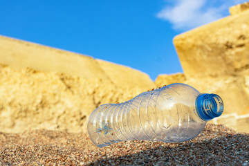 plastic bottle on the sea sand. water saving.