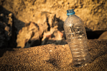 plastic bottle on the sea sand. water saving.