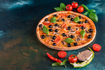 Tasty fresh hot pizza against a dark background. Pizza, food, vegetable, mushrooms.  It can be used as a background