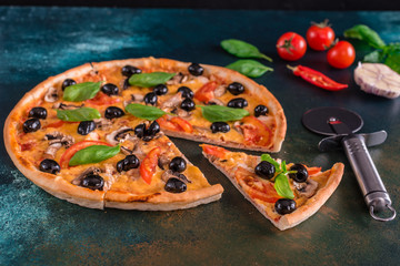 Tasty fresh hot pizza against a dark background. Pizza, food, vegetable, mushrooms.  It can be used as a background