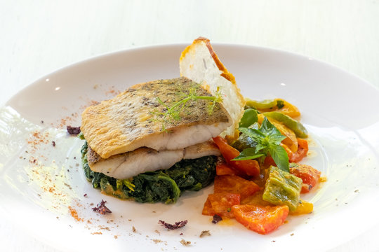 close up of pan seared grilled sea bass snapper fillet with healthy vegetables