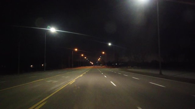 Driving On Empty Six Lane Highway At Night With Lots Of Lights And In Winter Time