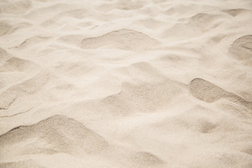 Fine beach sand in the summerBackground with copy space and visible sand texture.