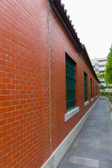 Grid windows on red brick walls. Perspective of a building.