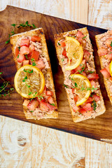Appetizer bruschetta with tuna and tomatoes. Italian cuisine.