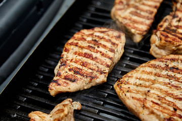 Grilled turkey meat. Steak turkey grill on on huge gas grill . Picnic. Summer. Top view. Flat lay. Copy space.