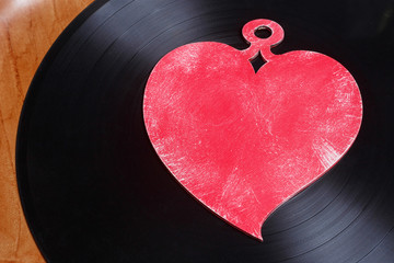 LP vinyl record with red heart. This is nostalgic love song, retro styled.