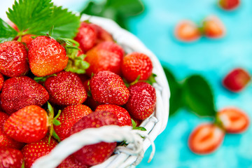 Ripe red strawberries on blue table, Strawberries in white basket. Fresh strawberries. Beautiful strawberries. Diet food. Healthy, vegan. Copy space.