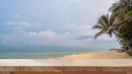 Wood table top and blurred summer beach background