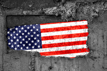 The flag of United States of America on a dirty wooden surface, built into a concrete base, with...