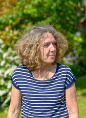 Attractive middle-aged woman walking in a garden