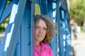 Smiling attractive woman looking through a bridge