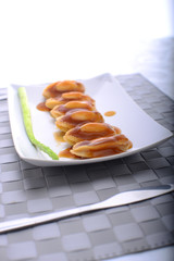 wide spread of abalone servings in a fine dining setting