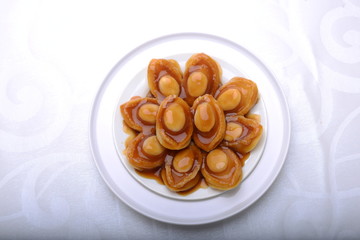 wide spread of abalone servings in a fine dining setting