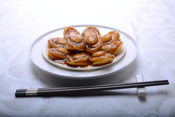 wide spread of abalone servings in a fine dining setting