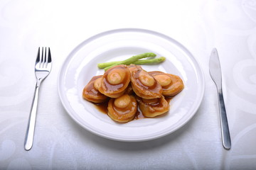 wide spread of abalone servings in a fine dining setting