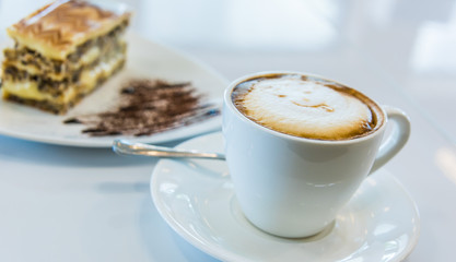 Cup of coffee and cake on the table
